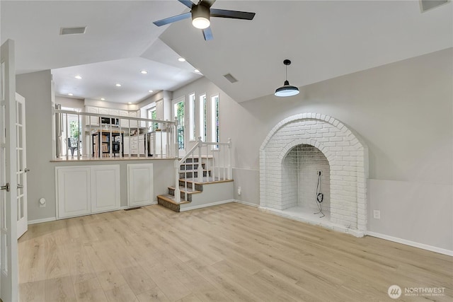 unfurnished living room featuring a ceiling fan, baseboards, light wood finished floors, and visible vents