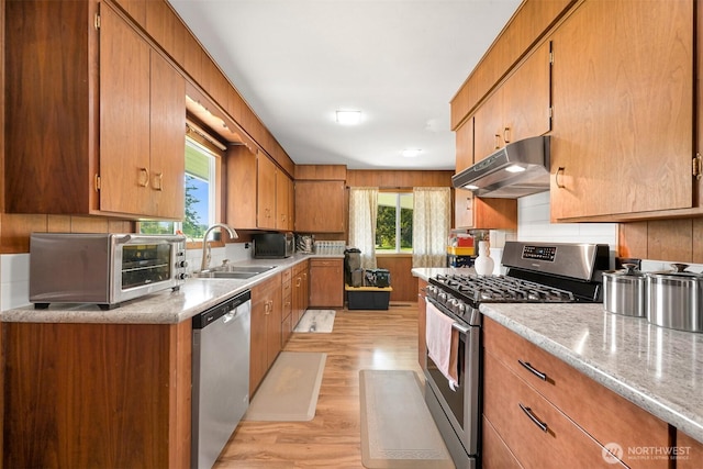 206 Kelly Rd, Bellingham, WA 98226 - kitchen featuring light wood finished floors, a sink, under cabinet range hood, light countertops, and appliances with stainless steel finishes