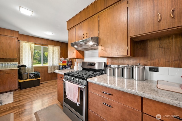 206 Kelly Rd, Bellingham, WA 98226 - kitchen with stainless steel range with gas cooktop, under cabinet range hood, light wood-style floors, and brown cabinets