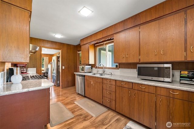 206 Kelly Rd, Bellingham, WA 98226 - kitchen with light wood-style flooring, a sink, wall chimney exhaust hood, stainless steel appliances, and wood walls