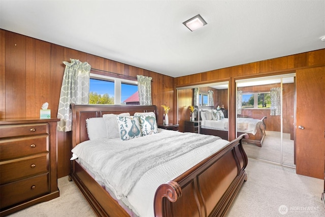 206 Kelly Rd, Bellingham, WA 98226 - bedroom with light colored carpet, two closets, and wooden walls