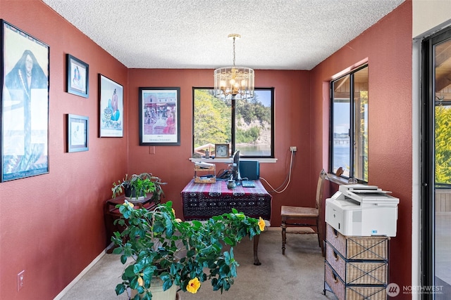 office featuring carpet flooring, a chandelier, a textured ceiling, baseboards, and a textured wall