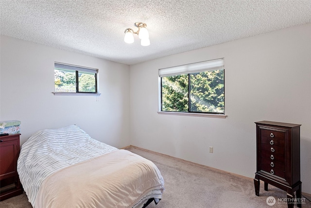 carpeted bedroom with a textured ceiling
