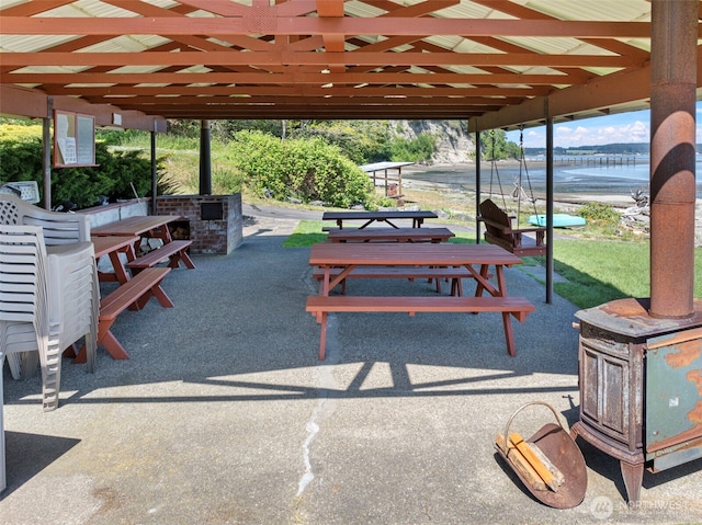 view of property's community featuring a water view and a patio area