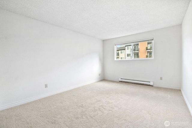 unfurnished room with carpet, a textured ceiling, baseboards, and a baseboard radiator