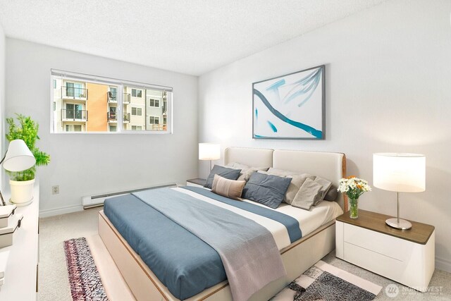15210 Macadam Rd S Unit E204, Tukwila, WA 98188 - carpeted bedroom with a baseboard heating unit, a textured ceiling, and baseboards
