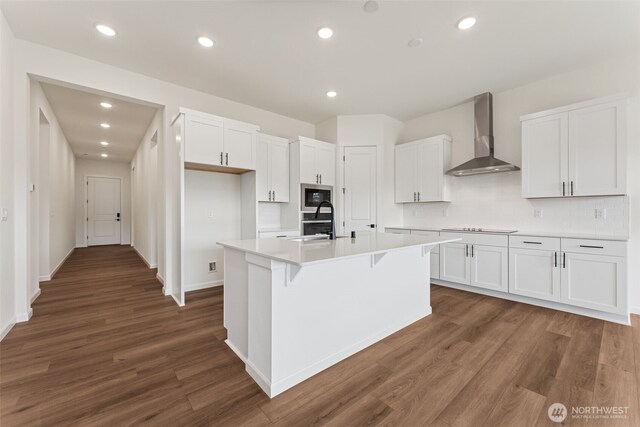 5741 Thornhill Ave SW Unit 326, Port Orchard, WA 98367 - kitchen with wall chimney range hood, stainless steel appliances, white cabinets, wood finished floors, and recessed lighting