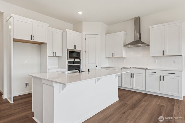 5741 Thornhill Ave SW Unit 326, Port Orchard, WA 98367 - kitchen with wall chimney range hood, a sink, dark wood finished floors, white cabinetry, and stainless steel microwave
