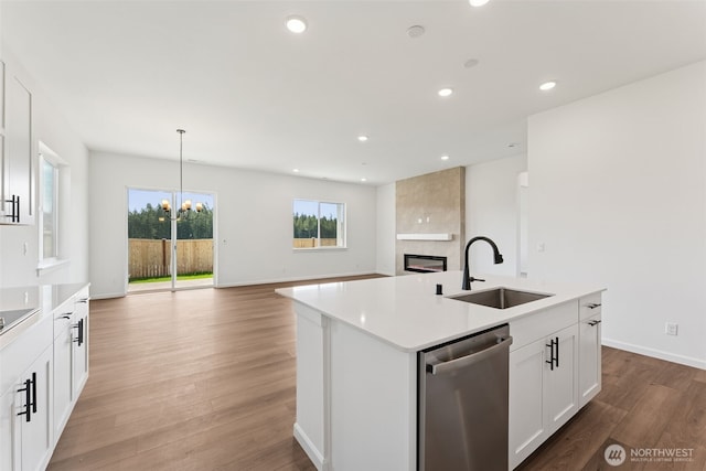 5741 Thornhill Ave SW Unit 326, Port Orchard, WA 98367 - kitchen featuring stainless steel dishwasher, a sink, a fireplace, light wood-type flooring, and recessed lighting