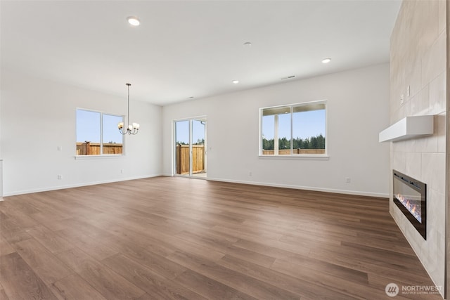 5741 Thornhill Ave SW Unit 326, Port Orchard, WA 98367 - unfurnished living room with a fireplace, a chandelier, dark wood finished floors, baseboards, and recessed lighting