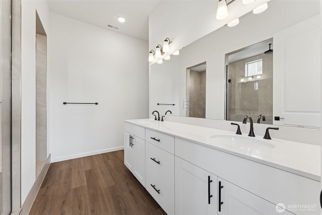 5741 Thornhill Ave SW Unit 326, Port Orchard, WA 98367 - bathroom featuring a shower stall, wood finished floors, double vanity, and baseboards