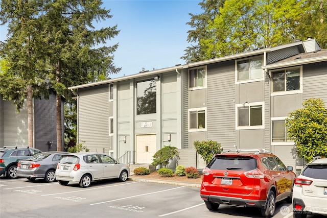 view of building exterior with uncovered parking