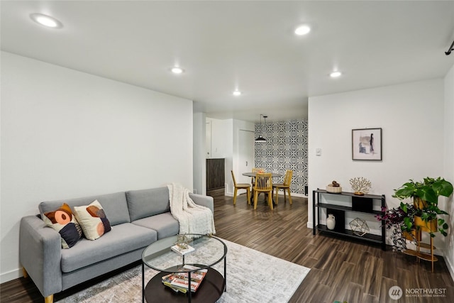 living room with recessed lighting, dark wood-style floors, and baseboards