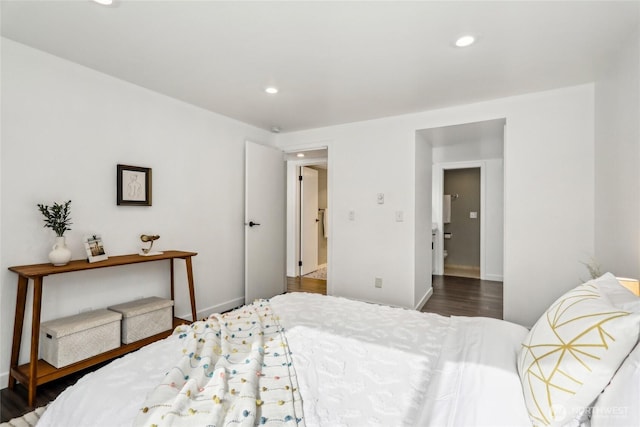 bedroom with wood finished floors, recessed lighting, and baseboards