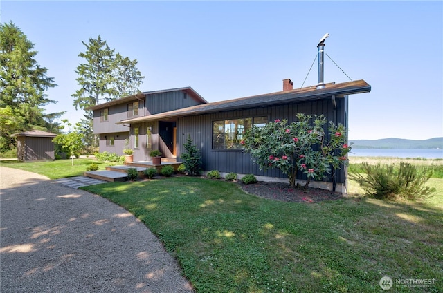 15410 Sandridge Rd, Long Beach, WA 98631 - view of front facade featuring a front lawn, a chimney, and a water view