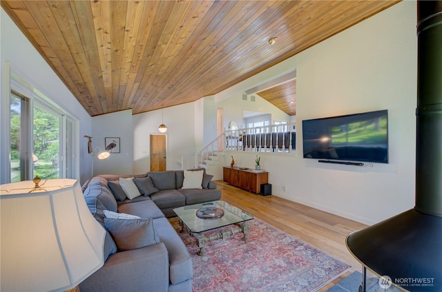 15410 Sandridge Rd, Long Beach, WA 98631 - living room featuring wooden ceiling, wood finished floors, stairway, a wood stove, and vaulted ceiling