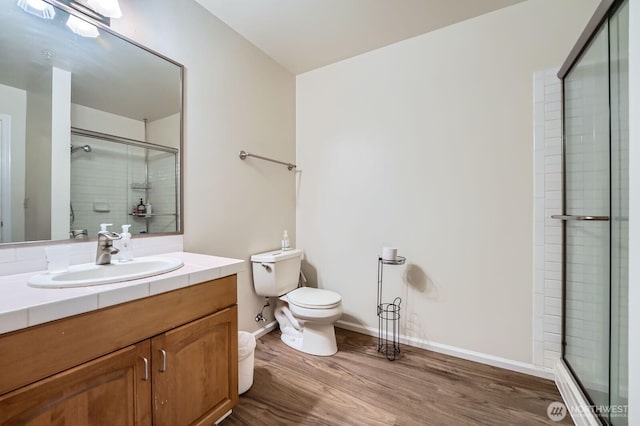 3201 Pacific Ave Unit 305, Tacoma, WA 98418 - full bath with a stall shower, toilet, wood finished floors, baseboards, and vanity