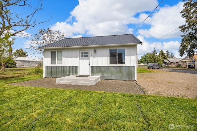 108 Centre St S, Rainier, WA 98576 - back of house with a yard, metal roof, and board and batten siding