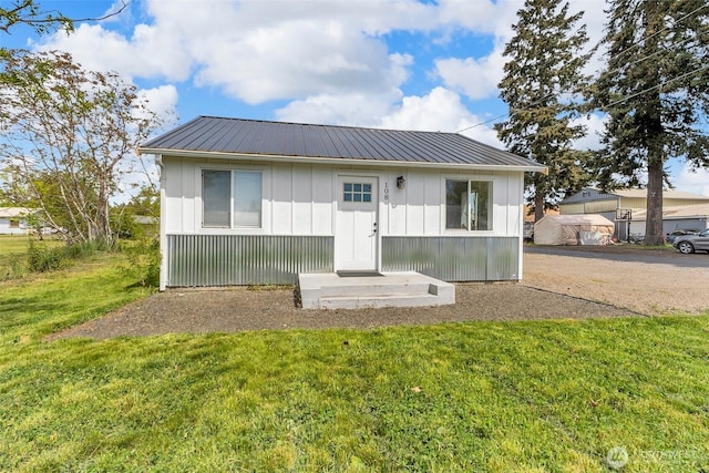 108 Centre St S, Rainier, WA 98576 - view of front of property featuring a front lawn, metal roof, and board and batten siding