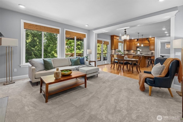 living area with healthy amount of natural light, recessed lighting, and baseboards