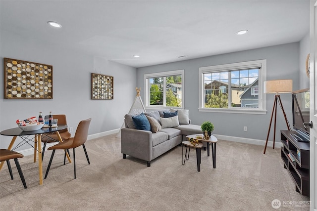 living room featuring light carpet, baseboards, and recessed lighting