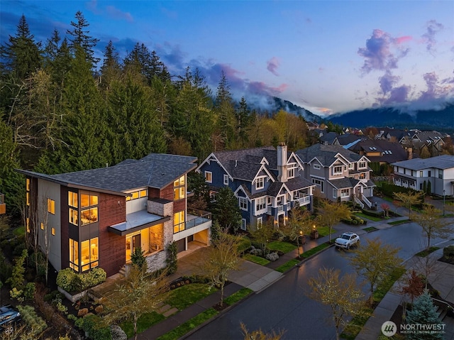 aerial view at dusk featuring a residential view