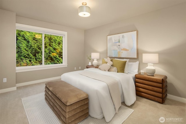 bedroom featuring light colored carpet and baseboards