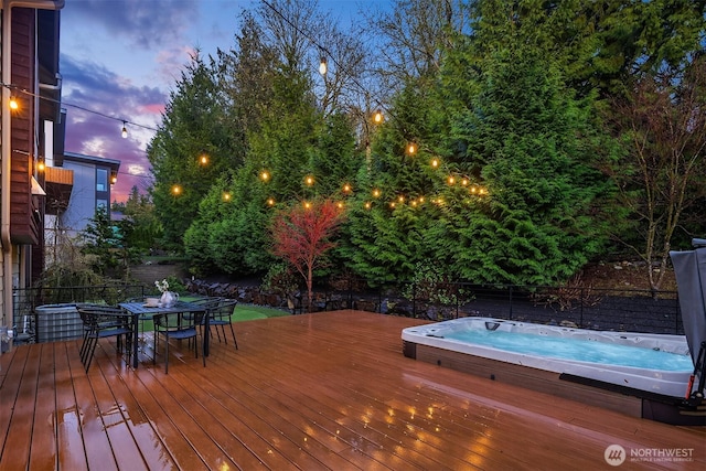 deck with hot tub deck surround and a fenced backyard