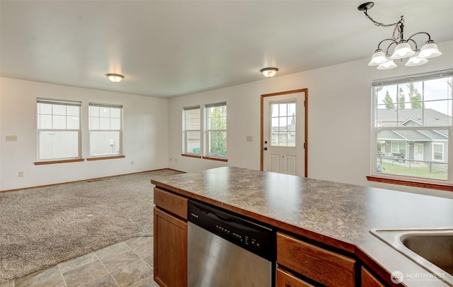 kitchen with stainless steel dishwasher, light colored carpet, a chandelier, open floor plan, and pendant lighting