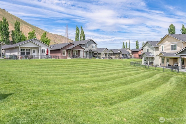view of yard with a residential view and a mountain view