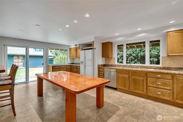 1002 30th St NE, Auburn, WA 98002 - kitchen featuring dishwasher, white refrigerator with ice dispenser, decorative backsplash, recessed lighting, and a sink