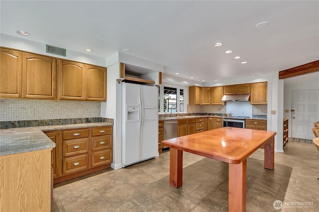 1002 30th St NE, Auburn, WA 98002 - kitchen featuring appliances with stainless steel finishes, under cabinet range hood, recessed lighting, backsplash, and brown cabinetry