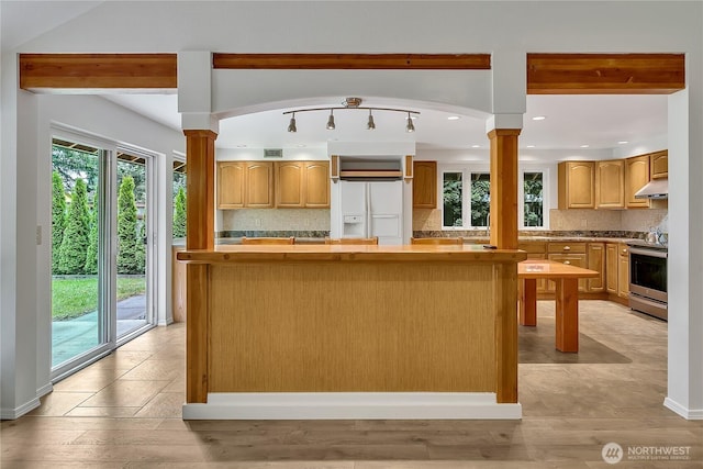 1002 30th St NE, Auburn, WA 98002 - kitchen featuring stainless steel range with electric stovetop, ornate columns, plenty of natural light, and recessed lighting