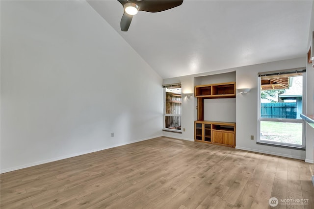 1002 30th St NE, Auburn, WA 98002 - unfurnished living room with lofted ceiling, light wood-type flooring, a ceiling fan, and baseboards