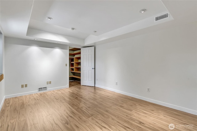 1002 30th St NE, Auburn, WA 98002 - spare room with a raised ceiling, baseboards, light wood finished floors, and recessed lighting