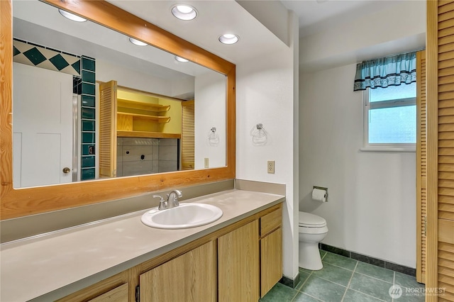 1002 30th St NE, Auburn, WA 98002 - bathroom with toilet, vanity, tile patterned flooring, recessed lighting, and baseboards