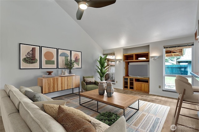 1002 30th St NE, Auburn, WA 98002 - living area featuring high vaulted ceiling, wood finished floors, ceiling fan, and baseboards