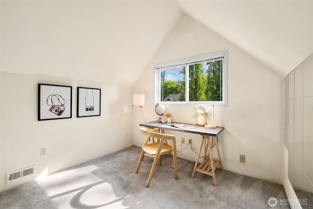 home office with lofted ceiling and carpet floors