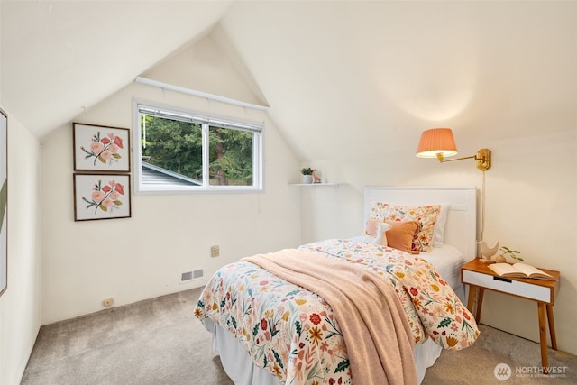 bedroom featuring carpet floors and lofted ceiling