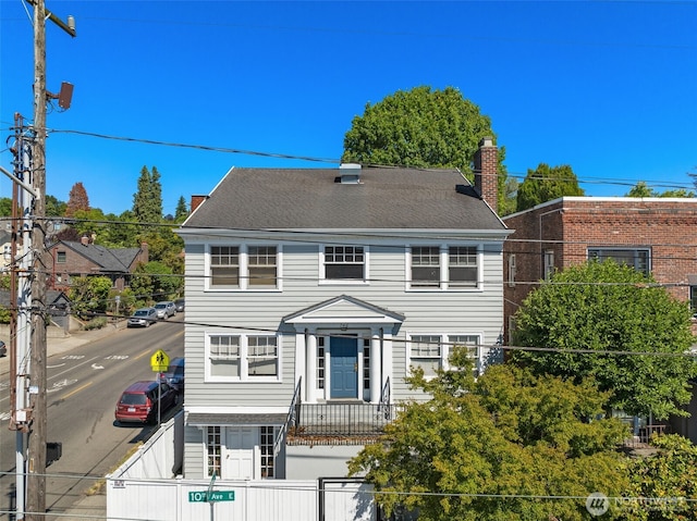 746 10th Ave E, Seattle, WA 98102 - view of front facade featuring a chimney and fence