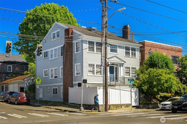 746 10th Ave E, Seattle, WA 98102 - view of front facade featuring fence and a chimney