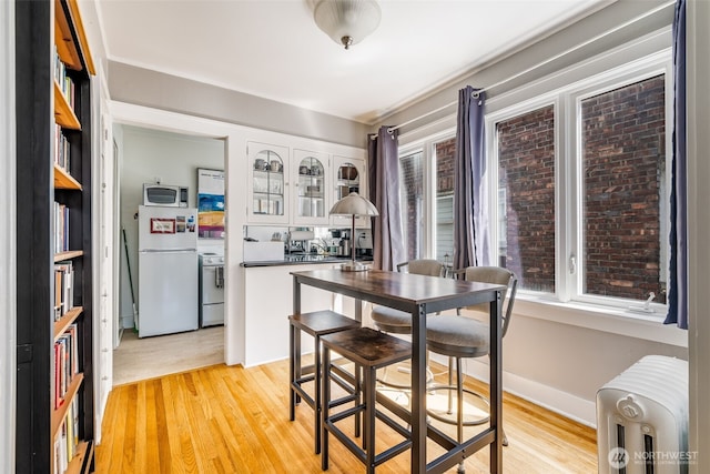 746 10th Ave E, Seattle, WA 98102 - dining room featuring light wood finished floors and radiator heating unit