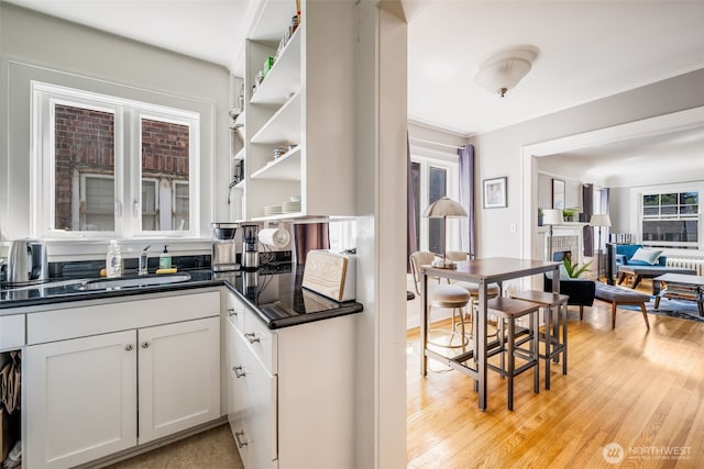 746 10th Ave E, Seattle, WA 98102 - kitchen with a sink, a fireplace, open shelves, and dark countertops