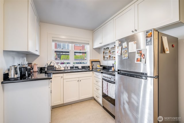 746 10th Ave E, Seattle, WA 98102 - kitchen with dark countertops, white cabinets, appliances with stainless steel finishes, and a sink