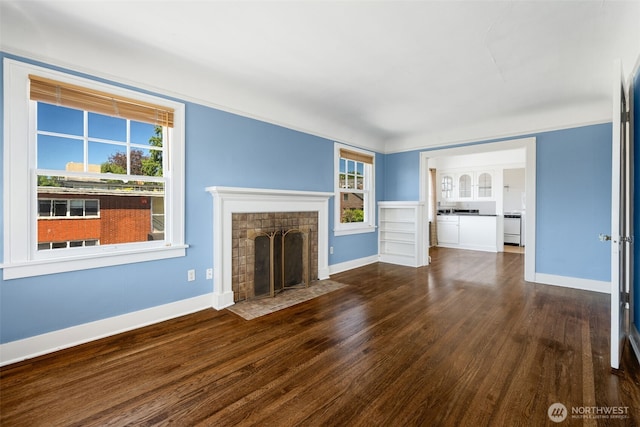 746 10th Ave E, Seattle, WA 98102 - unfurnished living room with baseboards, a fireplace with flush hearth, and wood finished floors