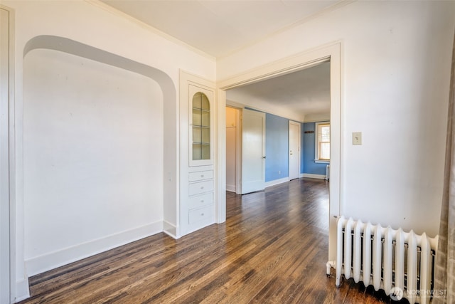 746 10th Ave E, Seattle, WA 98102 - unfurnished room featuring dark wood finished floors, baseboards, ornamental molding, and radiator heating unit