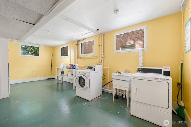 746 10th Ave E, Seattle, WA 98102 - laundry room featuring baseboards, washing machine and dryer, and a sink