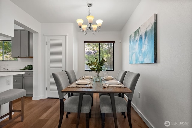4822 S M St, Tacoma, WA 98408 - dining space featuring a chandelier, healthy amount of natural light, dark wood-style floors, and baseboards