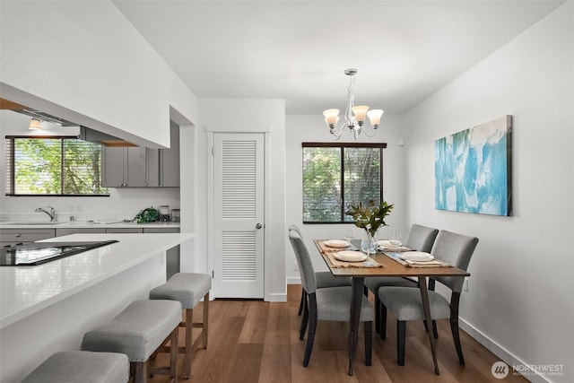 4822 S M St, Tacoma, WA 98408 - dining area with a chandelier, healthy amount of natural light, dark wood-style floors, and baseboards