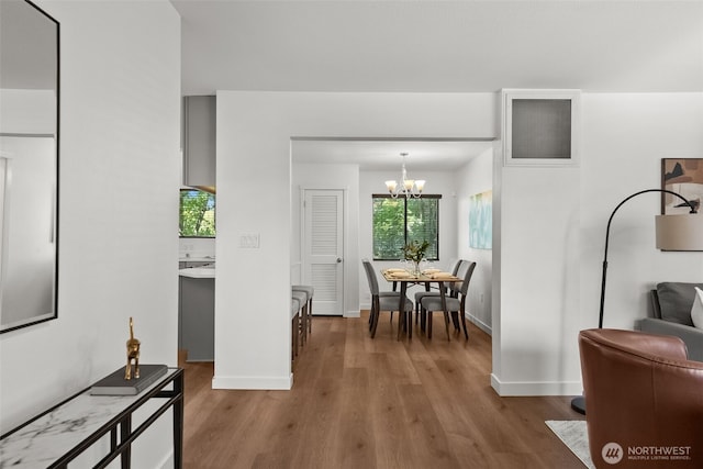 4822 S M St, Tacoma, WA 98408 - dining room featuring a chandelier, wood finished floors, and baseboards